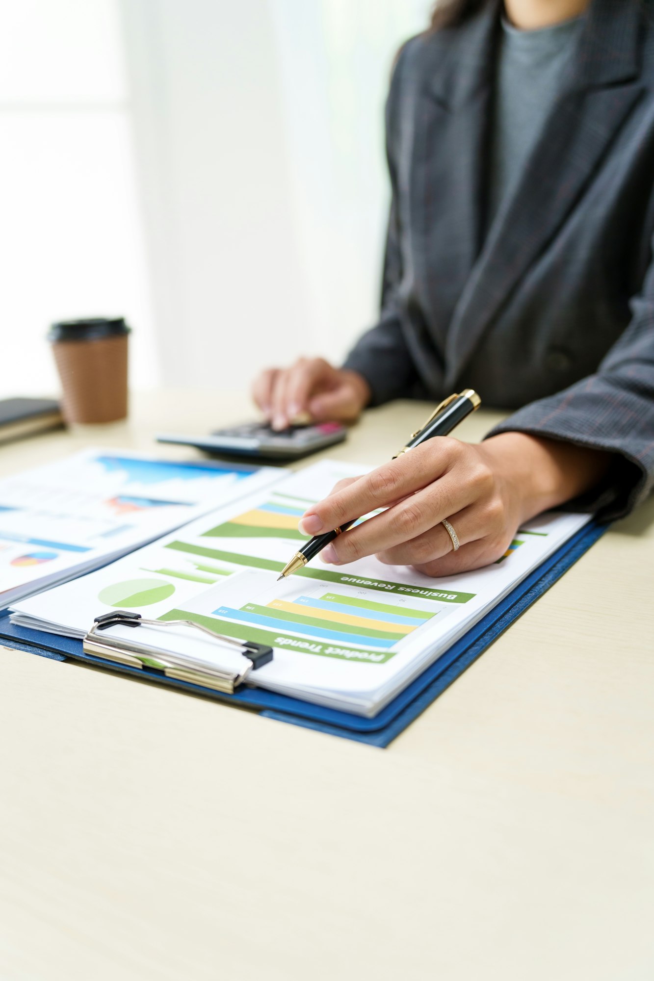 Businesswoman in a grey suit works from home, specializing in policy and planning analysis